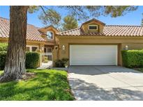 Charming home with a red tile roof, manicured lawn and lush landscaping at 7988 Harbour Towne Ave, Las Vegas, NV 89113