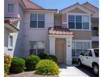 Charming two-story townhome with well-maintained landscaping and a welcoming front entrance at 8555 W Russell Rd # 2020, Las Vegas, NV 89113