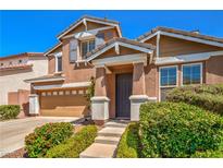 Inviting two-story home with a well-manicured lawn and an attached two-car garage at 10116 Nash Peak Ave, Las Vegas, NV 89166