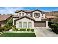 Charming two-story home with a manicured lawn and an attached two-car garage at 11 Morninglow Pass, Henderson, NV 89052