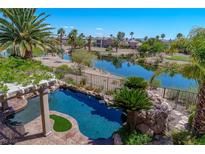 Inviting backyard pool overlooking the serene lake and lush greenery, a perfect outdoor oasis at 11359 Winter Cottage Pl, Las Vegas, NV 89135