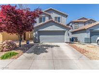 Charming two-story home features a well-maintained front yard with mature landscaping and a two-car garage at 11739 Village Arbor St, Las Vegas, NV 89183