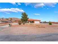Charming single-story home featuring desert landscaping, a spacious driveway, and mountain views at 120 N Phyllis St, Las Vegas, NV 89110