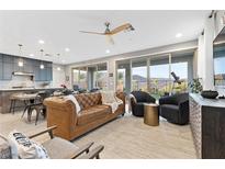 Bright, open living space featuring a neutral color palette and sliding doors with mountain views at 14 Parco Fiore Ct, Henderson, NV 89011