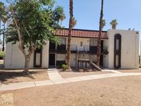 Exterior elevation of two-story unit with dark brown trim, stucco siding, and a tile roof at 1405 Vegas Valley Dr # 270, Las Vegas, NV 89169