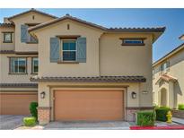 Charming two-story home with a two-car garage and tan stucco exterior at 172 Petaluma Valley Dr, Las Vegas, NV 89138