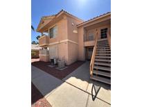Two-story home with stucco exterior, balcony, and stairs leading to the upper level at 1830 N Pecos Rd # 155, Las Vegas, NV 89115