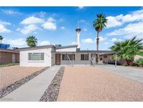 Charming single-story home with desert landscaping, covered carport, and a view of the Stratosphere Tower at 2112 Santa Ynez Dr, Las Vegas, NV 89104