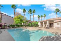 Relaxing community pool featuring plenty of seating and palm trees in a tranquil setting at 2615 W Gary Ave # 1041, Las Vegas, NV 89123