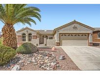 Charming single-story home with desert landscaping, large palm tree, and inviting curb appeal at 2810 Somerset Springs Dr, Henderson, NV 89052