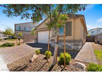 Charming single-story home featuring a brick driveway and a two-car garage, plus desert landscaping at 3709 Neblina Dr, Henderson, NV 89052
