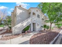 Charming condo featuring stucco exterior, red tile roof, and well-kept desert landscaping at 4324 W Lake Mead Blvd # 202, Las Vegas, NV 89108