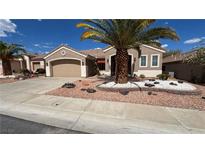 Charming single-story home featuring a low-maintenance desert landscape and a two-car garage at 494 Dart Brook Pl, Henderson, NV 89012