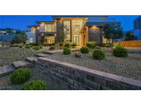 Striking two-story modern home featuring a stone facade and thoughtfully landscaped front yard with stone steps at 5 Crystal Tree Pass, Henderson, NV 89052