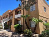 Multi-story condo building featuring balconies, desert landscaping, and stucco exterior at 5170 S Jones Blvd # 108, Las Vegas, NV 89118