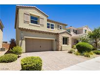 Beautiful two-story home featuring a 2-car garage, neutral color palette, brick driveway and manicured landscaping at 6730 Pivot Point St, Las Vegas, NV 89148