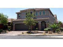 Charming two-story home with a well-manicured front yard and inviting curb appeal at 7861 Hamilton Pool Dr, Las Vegas, NV 89113