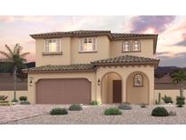 Charming two-story home features a tile roof, arched entryway, desert landscaping, and attached two-car garage at 880 Lorden St, Henderson, NV 89011