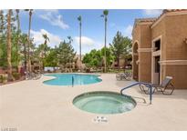 Community pool and spa area with lounge chairs and lush landscaping at 1150 N Buffalo Dr # 1007, Las Vegas, NV 89128