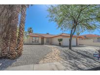 Charming single-story home featuring a tile roof, desert landscaping, and a stone walkway leading to the front door at 134 Saint Albans Dr, Henderson, NV 89015