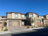 Contemporary two-story home featuring a brick driveway, desert landscaping, and an attached two-car garage at 201 Carmel Sky St, Las Vegas, NV 89138