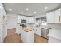 Bright kitchen features stainless steel appliances, white cabinets, quartz counters, and a butcher block island at 2107 Fountain Springs Dr, Henderson, NV 89074