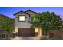 Charming two-story home featuring a brown garage door, stone accents, and manicured landscaping at 2276 Sky Island Dr, Henderson, NV 89002