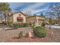 Charming home with well-maintained landscaping, a red-tile roof, and a two-car attached garage at 2520 Palmridge Dr, Las Vegas, NV 89134