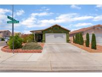 Charming single-story home with a well-manicured front yard and a two-car garage at 3617 Walnut Wood St, Las Vegas, NV 89129