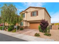 Two-story home featuring a brown two-car garage and a well-manicured lawn with beautiful landscaping at 3746 Asia Rd, North Las Vegas, NV 89032