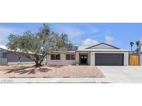 Charming single-story home with mature tree, solar panels, and a spacious two-car garage at 405 Oil Lantern Ln, Las Vegas, NV 89145