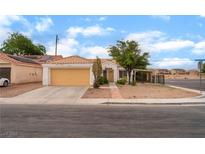 Charming single-story home features a stucco facade, gravel yard and two-car garage at 4110 Bonita Desert Ct, North Las Vegas, NV 89032