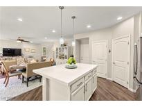 Bright kitchen featuring a large island with quartz countertops, pendant lighting, and modern appliances at 419 Vigo Port St, Las Vegas, NV 89138