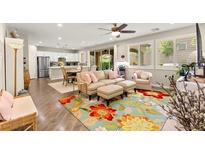 Bright open-plan living room with modern finishes, hardwood floors, and access to the backyard at 419 Vigo Port St, Las Vegas, NV 89138