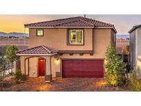 Two-story home boasts a red door, two-car garage, and manicured landscaping at 4433 Bayley Skye Ave # 104, Las Vegas, NV 89141