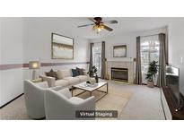 Bright living room featuring a fireplace, neutral tones, and comfortable seating at 4555 E Sahara Ave # 280, Las Vegas, NV 89104