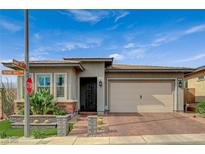 Charming single-story home featuring low maintenance desert landscaping, brick driveway, and a two car garage at 468 Harvest Rain, Las Vegas, NV 89011
