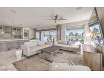 Spacious living room with modern furniture, recessed lighting, and sliding glass doors to the backyard at 4924 E Cactus Canyon Dr, Pahrump, NV 89061