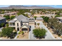 Beautiful two-story home featuring an attached garage and a well-maintained front yard with mature trees and shrubs at 5128 Blissful Valley Cir, Las Vegas, NV 89149