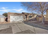 Charming single-story home featuring a two-car garage and desert landscaping at 5184 Mineral Lake Dr, Las Vegas, NV 89122