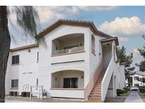 Inviting multi-level home with a private balcony, stucco walls, and stairway access to each level at 5650 E Sahara Ave # 2062, Las Vegas, NV 89142