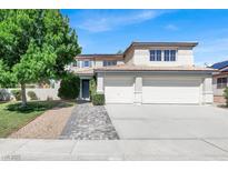 Charming two-story home with a well-manicured lawn and a spacious three-car garage and welcoming walkway at 6313 Giant Oak St, North Las Vegas, NV 89084