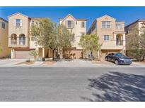 Inviting exterior of townhomes featuring desert landscaping and attached garages at 7363 San Pablin St, Las Vegas, NV 89139