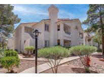 Beautiful condo with red tile roof, neutral stucco and mature landscaping at 7905 Idledale Ct # 102, Las Vegas, NV 89145