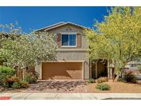 Charming two-story home featuring a well-maintained front yard and a two-car garage at 8164 Golden Cholla Ave, Las Vegas, NV 89179