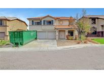 Charming two-story home with a tile roof and a two-car garage, awaiting landscaping and cleanup at 10135 Diving Duck Ave, Las Vegas, NV 89117