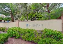 Attractive entrance sign to Silver Pines community with mature landscaping at 10525 Pine Glen Ave # 206, Las Vegas, NV 89144