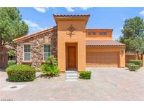 Charming home boasts stone accents, a tile roof, and meticulously manicured landscaping at 1252 Casa Palermo Cir, Henderson, NV 89011