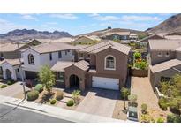 Beautiful home with a well-manicured front yard, attached two-car garage, and stunning mountain views at 133 Clouded Ave, Henderson, NV 89002