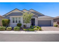 Charming single story home boasts manicured landscaping and a brick driveway at 2433 Cingoli St, Henderson, NV 89044